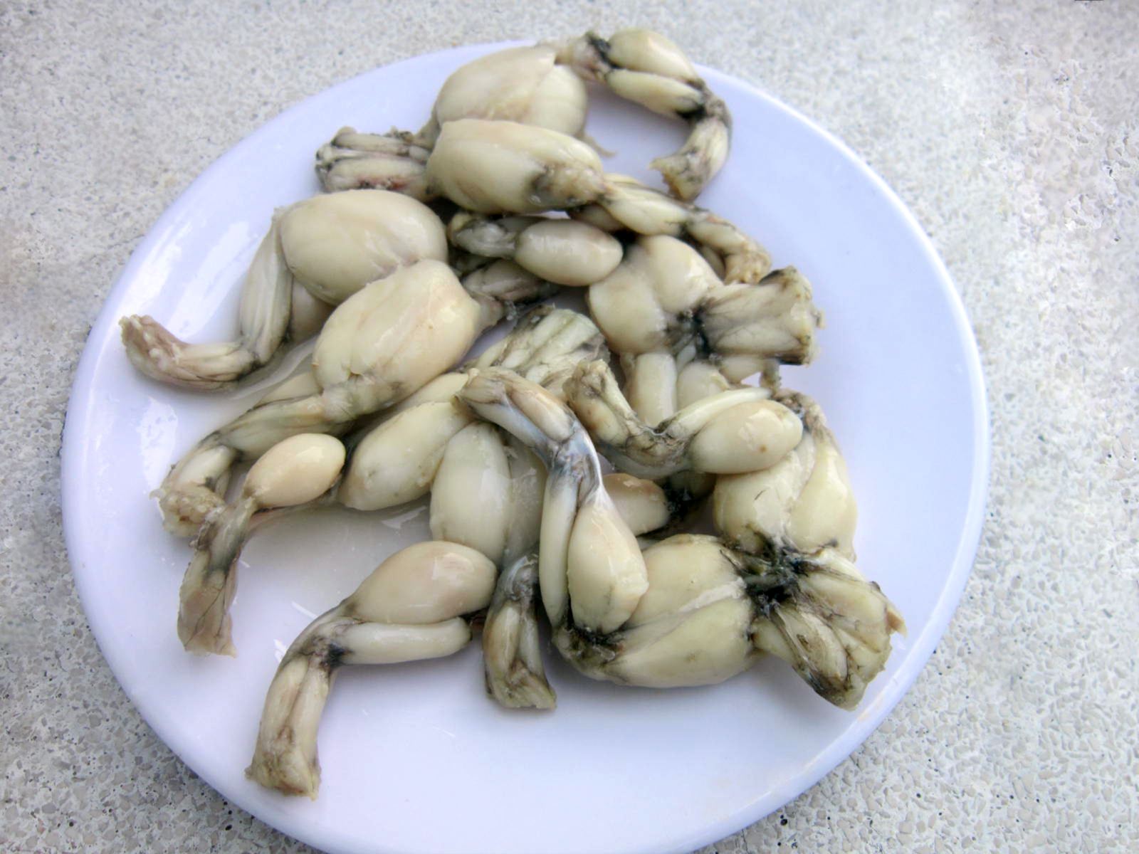 Checking Taste Of Cooked Frog Legs Checking Taste Of Cooked Frog Legs
