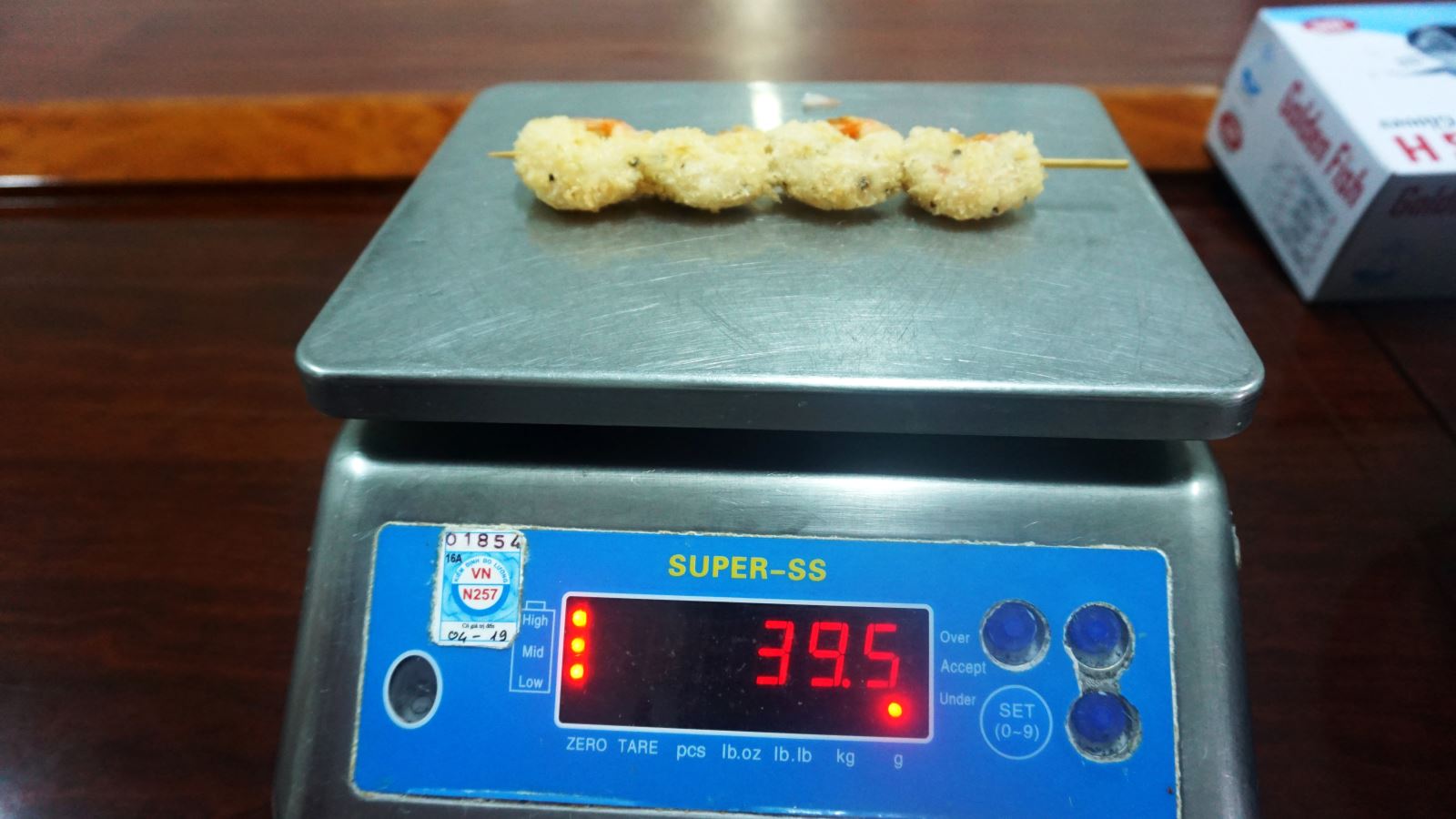 Checking Weight Of A Pre-fried Vannamei Shrimp Skewer. Credit: Silvera Food