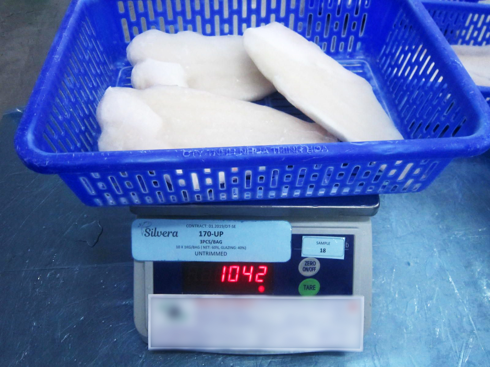 Checking The Total Weight Of Frozen Pangasius Well-Trimmed Fillets Checking The Total Weight Of Frozen Pangasius Well-Trimmed Fillets